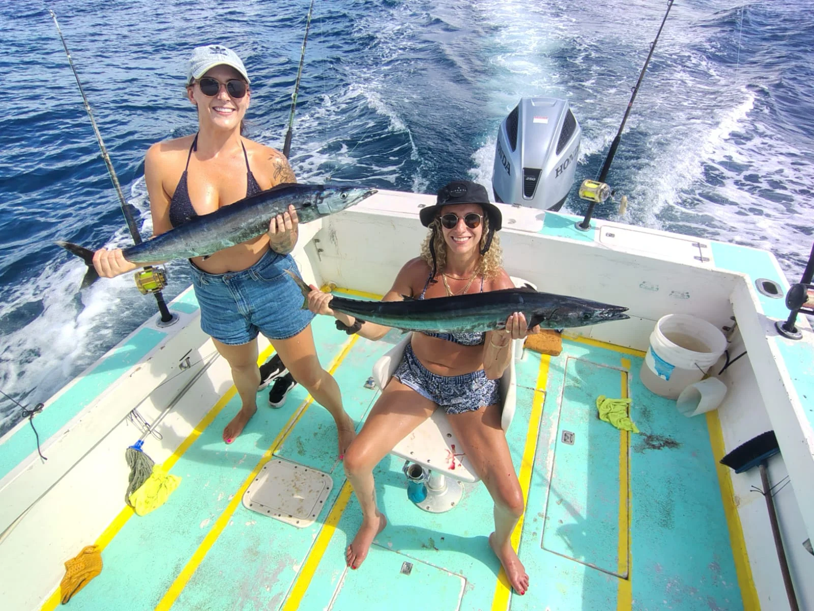 Two anglers holding wahoo caught during an offshore fishing charter from Jaco Costa Rica in August 2026