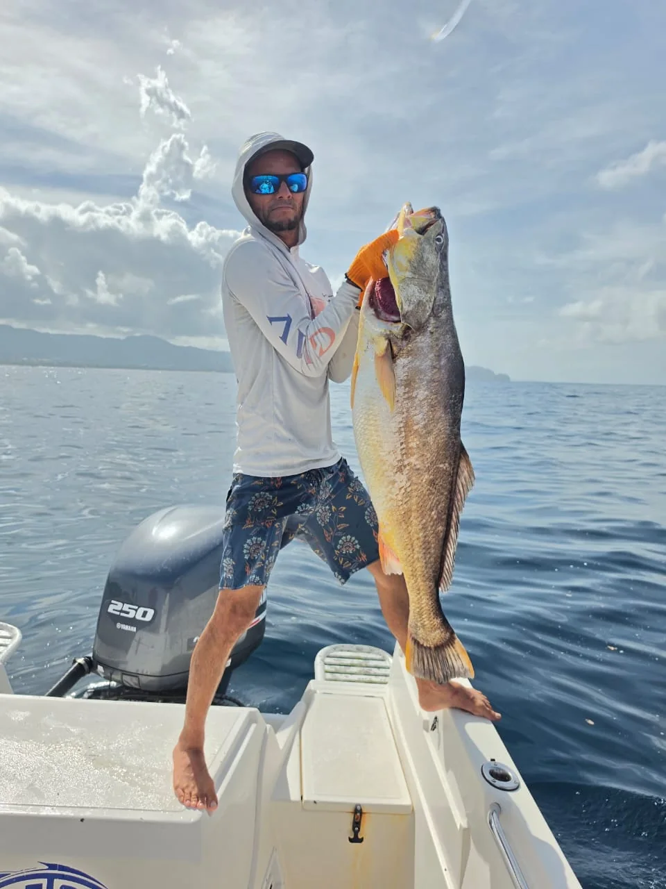 Angler standing with a large inshore trophy fish caught near Jaco Costa Rica in August 2026