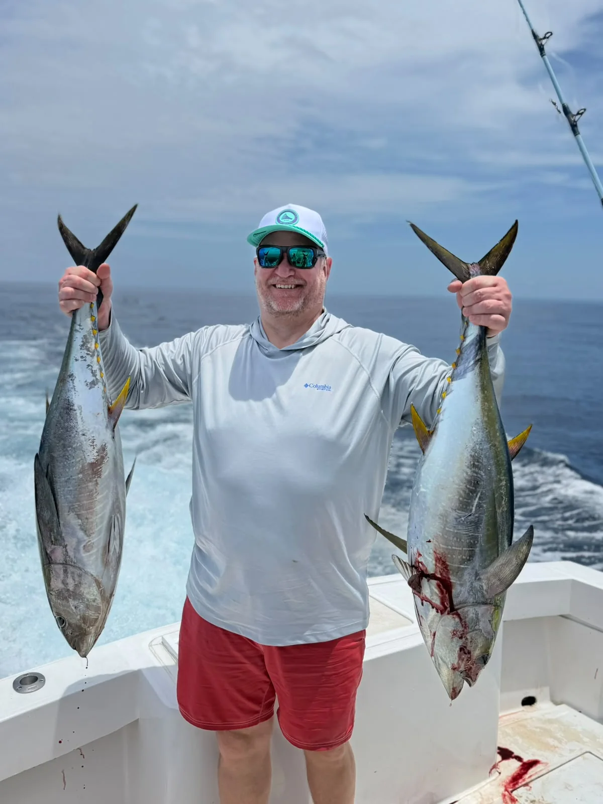 Angler displaying two yellowfin tuna after an offshore fishing trip from Jaco Costa Rica in August 2026