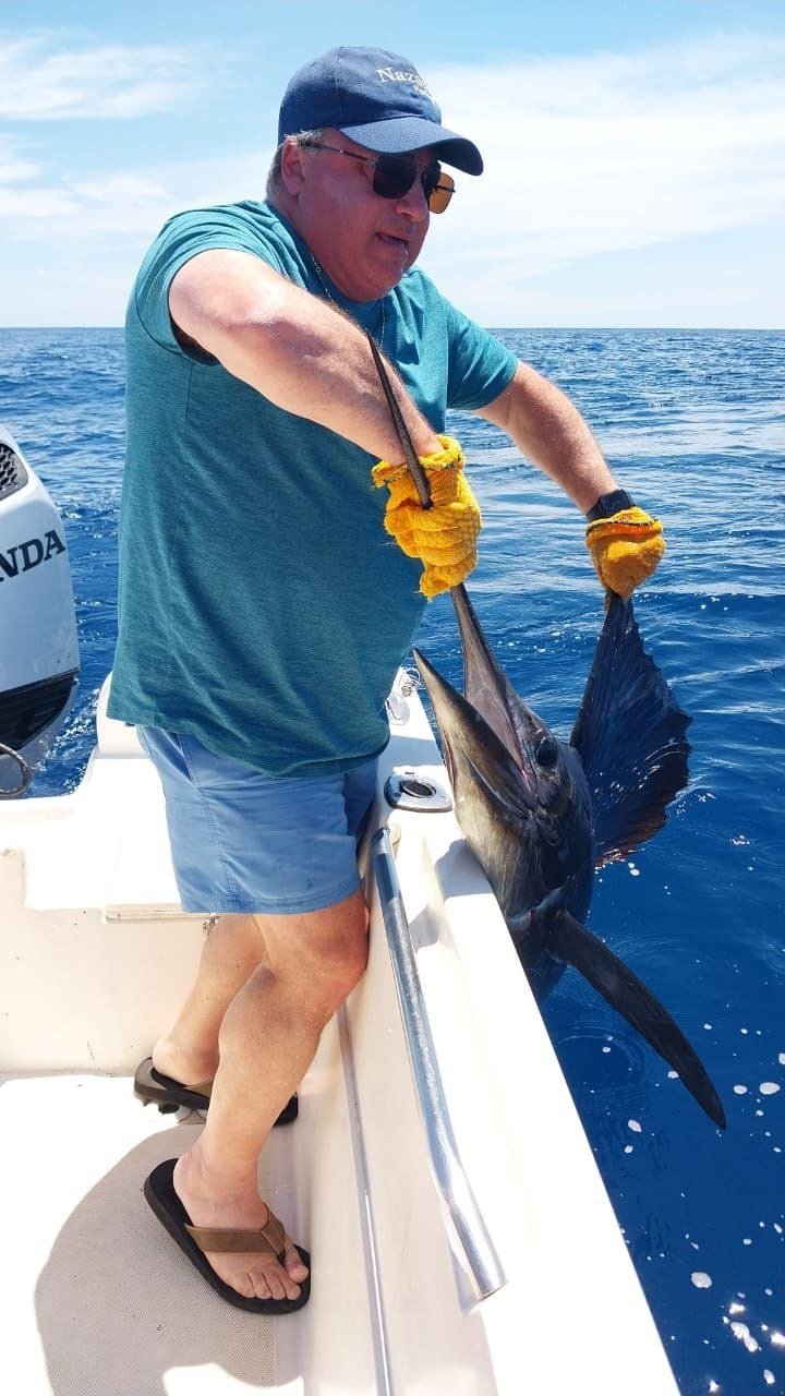 Sailfish Catch Jaco Costa Rica 7 Guest with sailfish during a Wahoo Sportfishing Jaco offshore fishing charter in Costa Rica