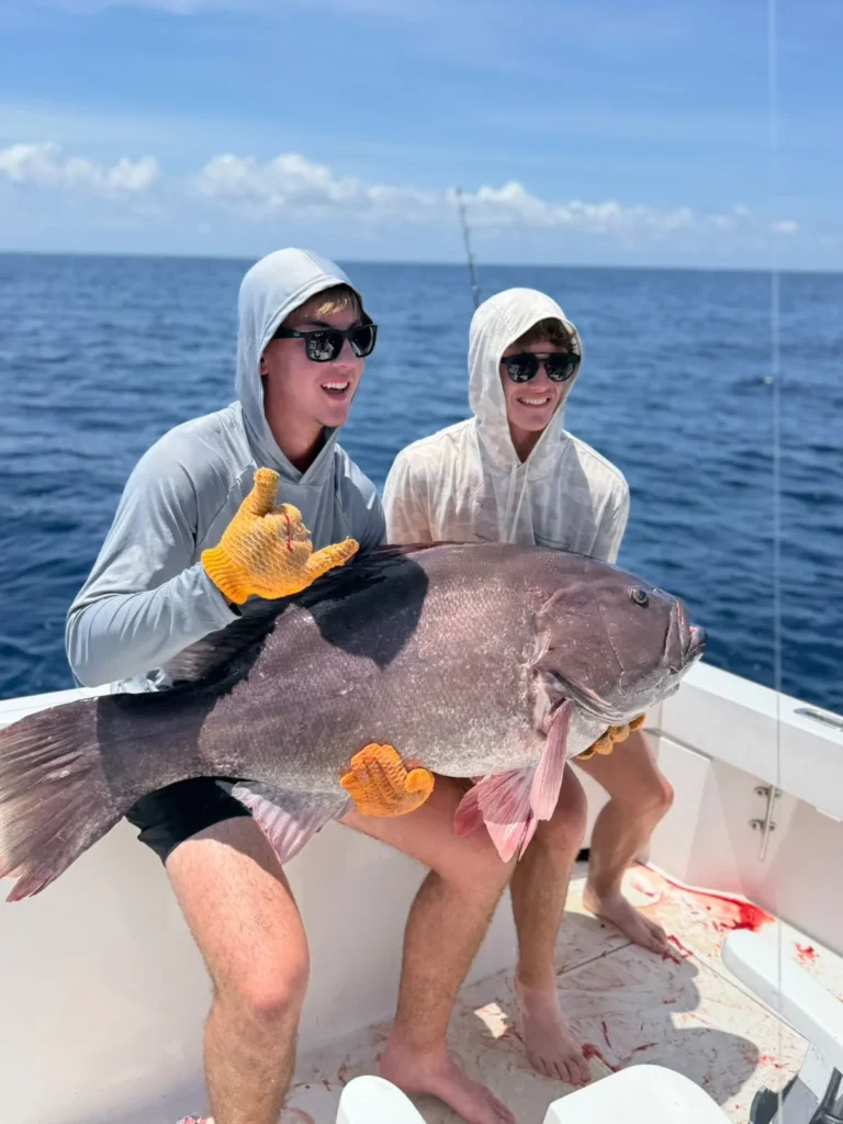 Young anglers posing with a very large grouper caught near Jaco Costa Rica in July 2026