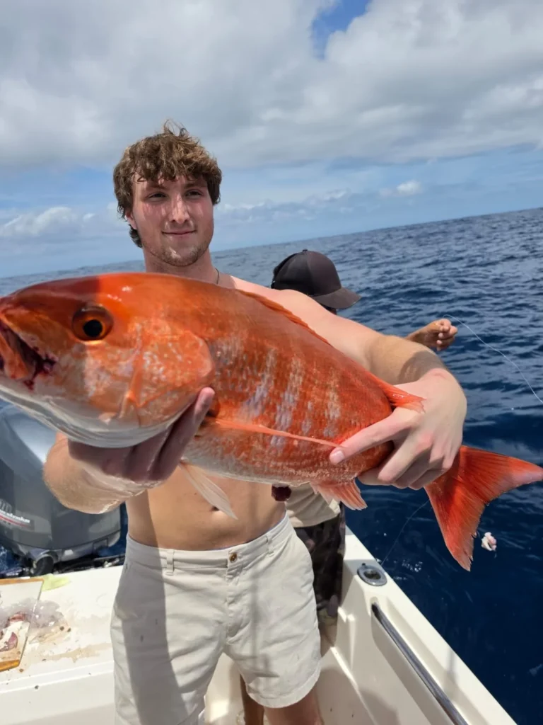 Angler holding a large red snapper caught during a fishing trip near Jaco Costa Rica in August 2026