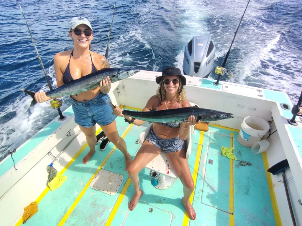 Two anglers holding wahoo caught during an offshore fishing charter from Jaco Costa Rica in August 2026